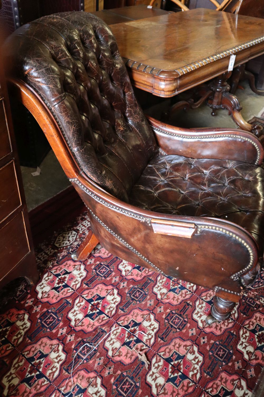 A Victorian mahogany library chair, upholstered in buttoned brown leather, width 64cm height 90cm